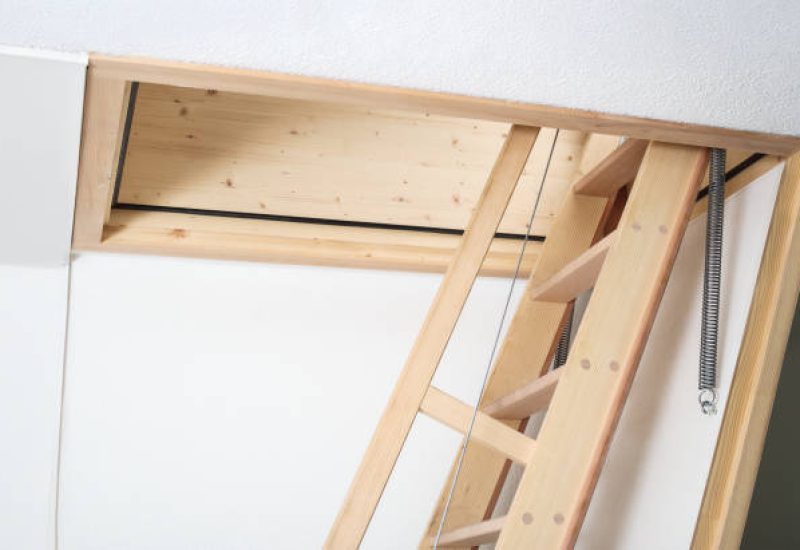 Bright white converted loft room with sloped ceiling and natural light