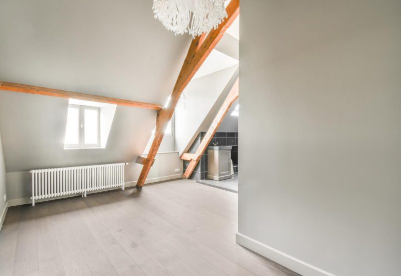 Finished loft conversion bedroom with Velux roof window and sloped ceiling
