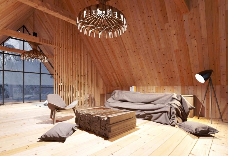 Converted loft bedroom with exposed wooden beams and Velux window