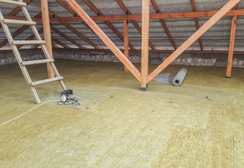 Loft space with insulation boards fitted between timber rafters