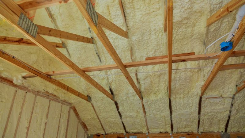 Mineral wool insulation being installed between loft roof rafters