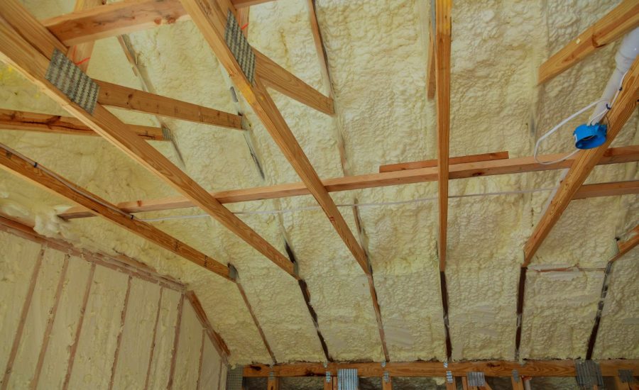 Mineral wool insulation being installed between loft roof rafters