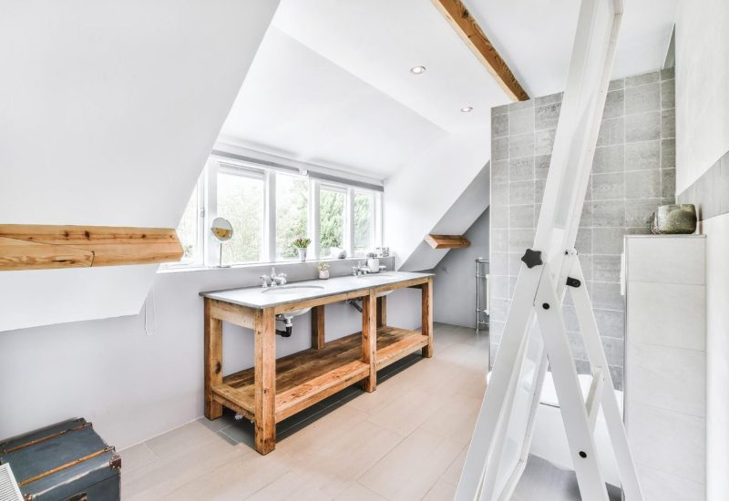Bright converted loft space with large roof windows and white walls